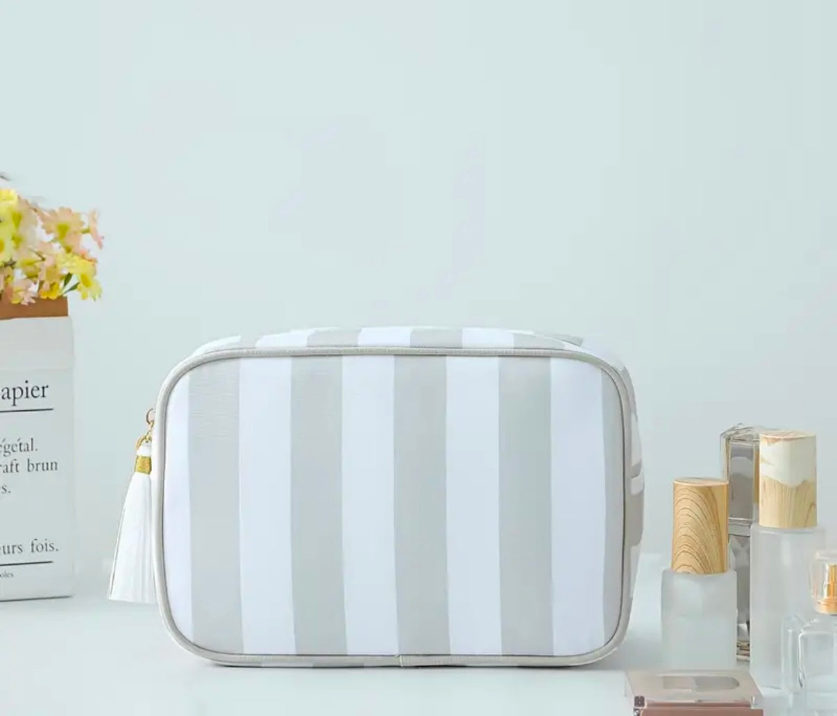 mac + mitchell striped and clear cosmetic bags styled with skincare products
