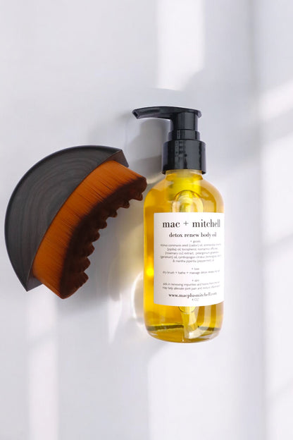 mac + mitchell body oil glass bottles with gold pump tops angled view