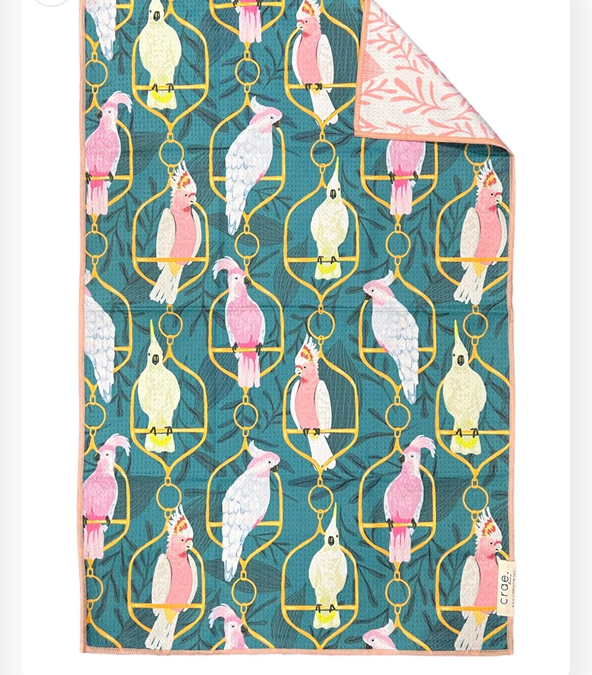 crae papillon microfiber hand towel with green and pink parrot pattern by mac + mitchell