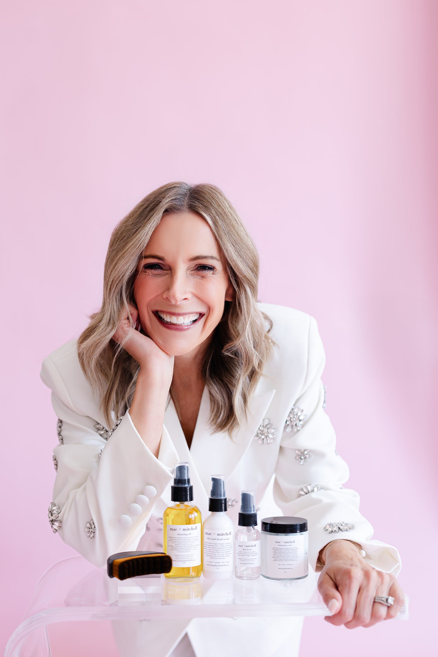 mac + mitchell crush collection founder kelly goodwin pumping cleansing oil into hand