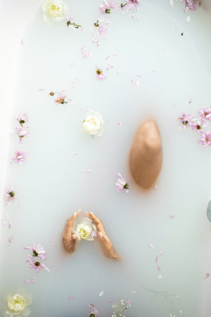 mac + mitchell lux milk bath products arranged with botanicals flat lay