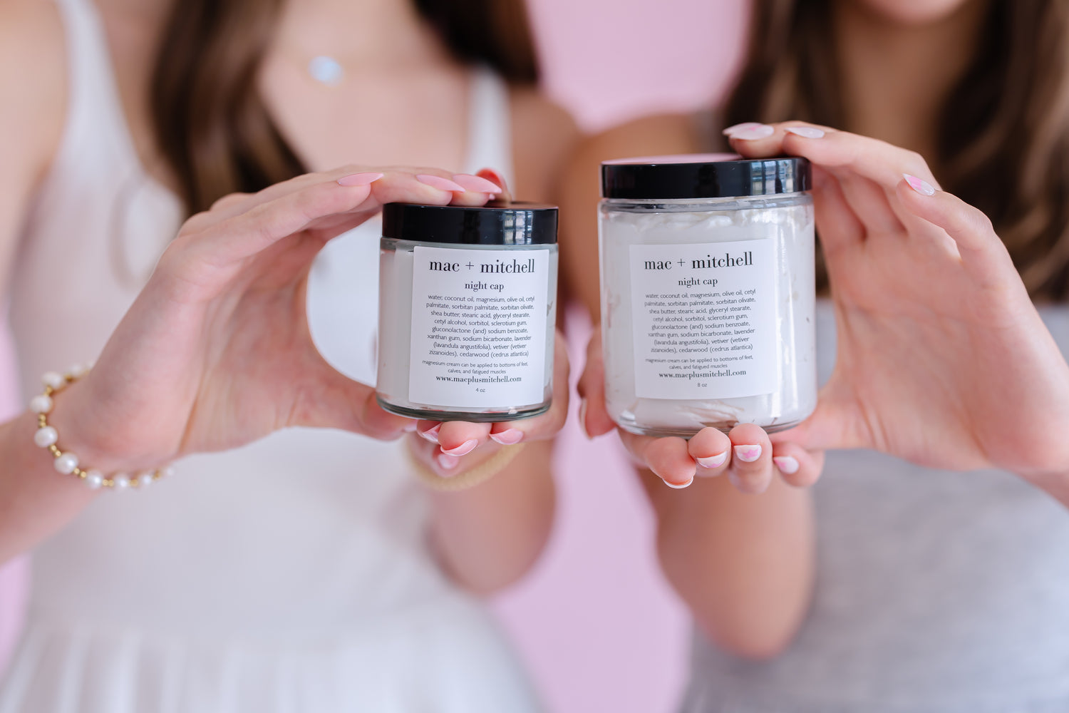 mac + mitchell nightcap magnesium cream in two sizes held in hands, glass jars with black lids