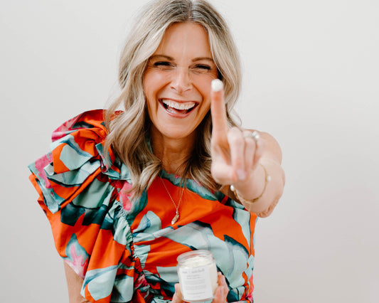 mac + mitchell founder kelly goodwin holding petal + pasture whipped tallow jar