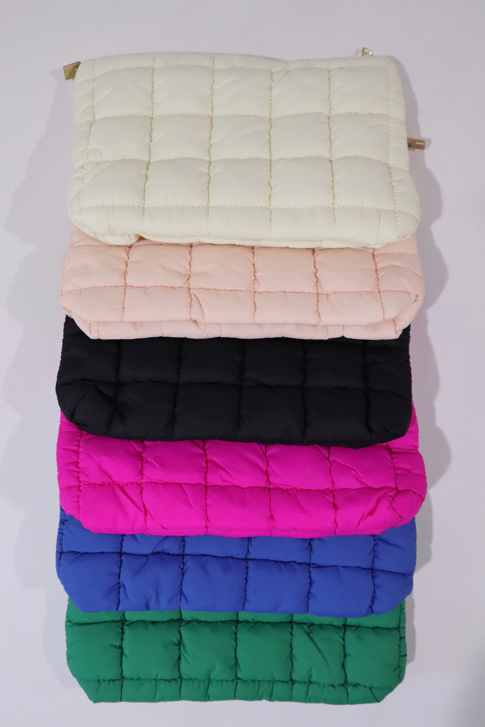 mac + mitchell vibrant puffer cosmetic bags stacked in kelly green black and royal blue