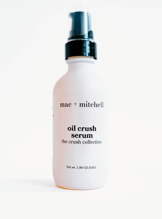 white glass bottle of oil crush facial serum with a black pump top.